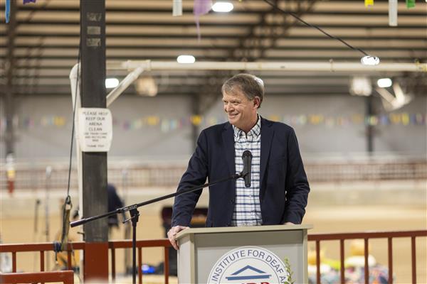 Allen Cope, President, AIDB Foundation Board of Directors, speaks to the audience from a podium.